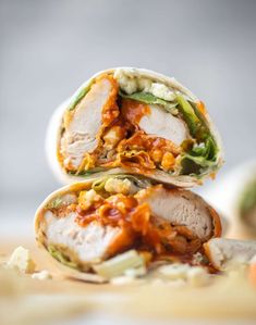 two burritos stacked on top of each other with meat and vegetables in them