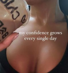 a woman with her breast exposed drinking from a cup that says, my confidence grows every single day