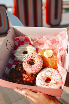 a box filled with lots of different types of doughnuts