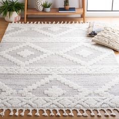 a white rug with tassels on the floor