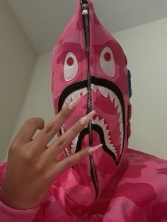 a person wearing a pink camo shark costume