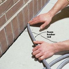 a brick wall being worked on by a man with a wrench and foam backer rod