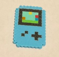 a blue gameboy shaped cake sitting on top of a table