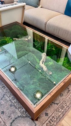 a glass coffee table sitting on top of a rug