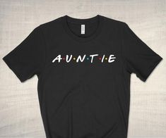 Auntie t-shirt - this awesome tee makes a great gift for your favorite auntie. Ideal for baby announcements, pregnancy reveals, birthdays, or holidays. She'll be there for you!Printed on Bella + Canvas unisex teeThis high quality t-shirt boasts super soft combed and ring spun Airlume cotton, a lightweight feel, and is ultra comfy. Retail fit and true unisex sizing. Fit for women is similar to a boyfriend tee (a little looser and longer). You may size down if you prefer a more fitted look. Please Fun Family T-shirt With Funny Text, Funny T-shirt With Text For Family, Funny Text Crew Neck T-shirt For Family Reunion, Funny T-shirt With Text For Family Reunion, Funny Text T-shirt For Family Reunion, Funny Text Short Sleeve T-shirt For Family Reunion, Funny T-shirt With Custom Text For Gift, Funny Text T-shirt For Gender Reveal, Funny T-shirt With Name Print For Gift