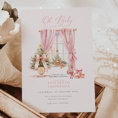 a baby's first christmas party card in a wooden box next to flowers and other decorations