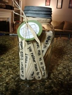 a jar filled with wooden spoons sitting on top of a counter next to a fire place