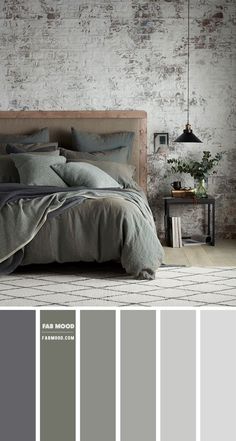 a bedroom with brick walls and grey bedding, along with neutral colors in the room