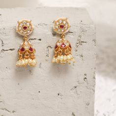 Description This timeless jhumki earring is perfectly crafted with polki stones on a gold-plated setting and finished with precious stones. An elegant wardrobe essential, these jhumki earrings will be your favorite. Style with the complementary accessories from the Vihara family for a grand look. This is the perfect choice for festival events and weddings. Product Information Materials used: 925 Silver with 1.0-microns Antique Gold Plating Stones: Semi precious stones Length: 3.5 cm Findings: Ho Luxury Fusion Style Jhumkas With Stone Work, Festive Elegant Jhumkas With Zari Work, Elegant Festive Jhumkas With Zari Work, Elegant Festive Zari Work Jhumkas, Kundan Temple Jewelry Earrings For Reception, Temple Jewelry Kundan Earrings For Receptions, Jhumkas With Stone Work For Eid Reception, Elegant Jhumkas With Zari Work For Festivals, Festive Temple Jewelry Pearl Earrings With Latkans