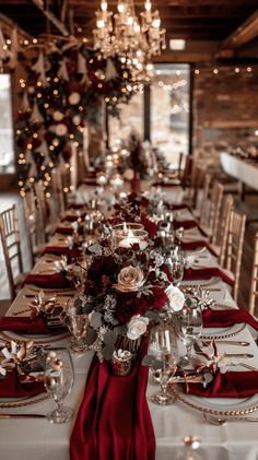 a long table is set with red napkins and place settings