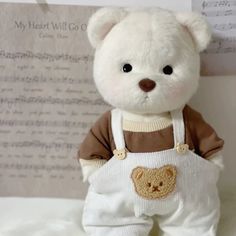 a white teddy bear wearing an apron