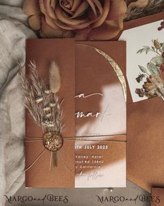 an image of wedding stationery with flowers on the bed and in the background is a rose