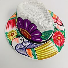 If you buy a product that is not available immediately for shipping, your whole order will be shipped together when all products are available. Otomí Hats Hand-painted in TAXCO,GUERRERO. Beautifully hand-painted Otomí designed hats made in Taxco. All designs vary, as they are hand painted, which means your hat will be unique and one-of a kind! Size: L (come with an adjustable elastic on the inside) Hand painted. Measurements: Inside: 25" circumference (elastic gives +/- 1 inch variation), Entire Hat Painting, Art Hats, Hats Ideas, Painted Purse, Mexican Hat, Colorful Hat, Mexican Fashion, Handpainted Bags, Elderly Woman