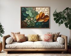 a living room with a couch, potted plant and large painting on the wall