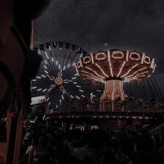 the ferris wheel is lit up at night