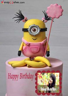 a pink and yellow cake with a minion on top