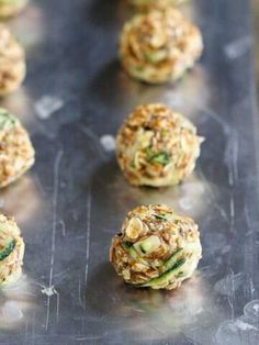 several balls of food sitting on top of a metal tray