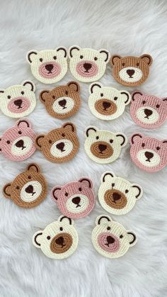 crocheted teddy bears are arranged in rows on a white furnishing surface