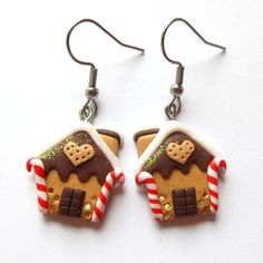 gingerbread house shaped earrings with candy canes on them