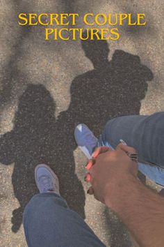 the shadow of a man holding a cell phone in his hand, while standing next to another person