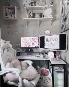 a desk with two computer monitors on it and stuffed animals in front of the monitor