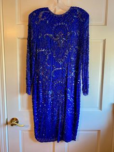 This is a vintage royal blue sequin and bead silk dress made in the mid-century.  Its gorgeous royal blue color is intense.  I don't see any missing beads or sequins.  It's been laundered at the dry cleaner and ready to wear to a formal affair like a wedding or engagement party.  It's truly spectacular! Its size is Medium.  It's below the knee.  If you love it like I do, you've truly found a treasure in my treasure trove.  Thanks for looking! Dress With Sequins, Royal Blue Dress, Royal Blue Color, Sequin Beading, Dress Clothes For Women, Blue Dress, Engagement Party, Silk Dress, Dress Making