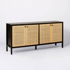 the sideboard is made out of wicker and black wood