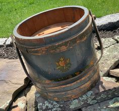 an old wooden barrel sitting on some rocks