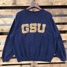 Vintage 90s NCAA Georgia Bulldogs Football University Sweatshirt Georgia Crewneck Georgia Sweater Embroidery Logo Blue Color Men's XL Label : CLASSIC SOFFE Label Size : XL Made in PAKISTAN Materials from 50% Cotton 50% Polyester Used Item With Condition 6/10 Refer Picture. Stain and No Holes. Lay Down Flat Measurement : - Width (armpit to armpit) and: 25.5 Inches - Length (shoulder to end of garment): 27 Inches We are selling used clothing with good condition. DO NOT EXPECT the item is like new condition. Shipping: DHL/FEDEX EXPRESS with TRACKING NUMBER. Track and Trace http://www.dhl.com http://www.fedex.com Parcel will be arrive within 3-6 business days or more due to location and custom clearing. Please PROVIDE your PHONE/CONTACT NUMBER for SHIPPING/DELIVERY purpose. VERY IMPORTANT ‼ fo Vintage Sweatshirt With Embroidered Text For Streetwear, Vintage Letter Embroidery Sweatshirt For Streetwear, Vintage Letter Embroidery Tops For Streetwear, Vintage College Sweatshirt With Embroidered Logo, Vintage Sweatshirt With Embroidered Logo For College, Vintage Embroidered Logo Sweatshirt For College, Vintage College Sweatshirt With Embroidered Text, Vintage Embroidered College Top, Vintage Embroidered Graphic Top For College