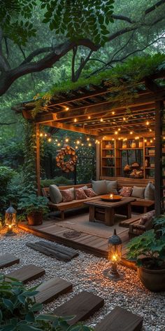 an outdoor living area is lit up with string lights