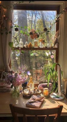 a table with flowers in vases on it next to a window