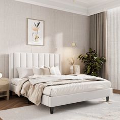 a white bed sitting in a bedroom on top of a hard wood floor next to a window