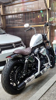 a motorcycle parked next to a white van