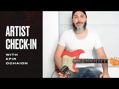 a man holding an electric guitar in front of a black and white background with the words artist checkin