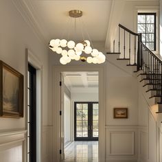 an entry way with stairs and chandelier