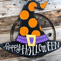 a sign that says happy halloween with a witch's hat and polka dots on it