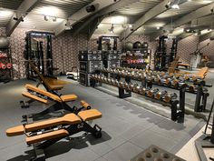 a large gym with rows of exercise equipment