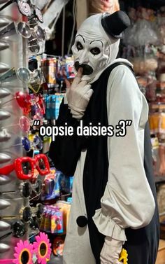 a person wearing a white mask and black vest in front of a store with the words cospisie daisies 3