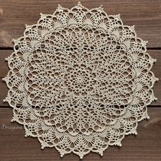 a white doily sitting on top of a wooden table