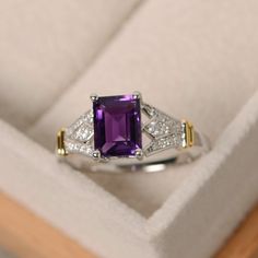 This ring features a 6mm*8mm emerald cut amethyst and sterling silver finished with gold and rhodium. Customization is available. It is made by hand, and it will take about 7 days to finish the ring after your payment is completed. Main stone: natural amethyst Amethyst weight: Approx 1.60 ct Metal type: sterling silver finished with rhodium Accent stone: cz Customization is available, I also can make it with 14k solid gold (white or yellow or rose) and diamond accent stone, just feel free to con Amethyst Birthstone Ring, Wedding Rings Emerald Cut, Amethyst Birthstone, Gold Color Ring, Wedding Ring Sizes, Jewelry Luxury, New Metal, Zircon Ring, Topaz Stone