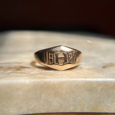 Beautiful vintage 1920's signet that was likely a class ring. This substantial ring features a letter H at the center, surrounded by the year of 1927 - nearly 100 whole years ago! The face shape is a cool geometric/trapezoidal design. Would make an awesome pinky ring if that is the finger it fits :) Wonderful vintage condition. A bit over 4.5 grams, this ring is heavy and well made for its size -- it has such a soothing presence on the finger! There is age appropriate wear and surface scratches Classic 14k Stamped Signet Ring For Commemoration, 14k Gold Heirloom Signet Ring For Commemoration, Heirloom 14k Gold Signet Ring For Commemoration, Antique 14k Gold Signet Ring For Commemoration, Classic Hallmarked Signet Ring For Commemoration, Classic Engraved Signet Ring For Commemoration, Classic Hallmarked Engraved Ring For Commemoration, Classic Engraved Hallmarked Ring For Commemoration, 14k Gold Engraved Ring With Initials For Collectors