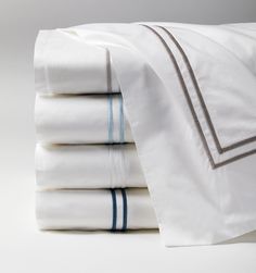 a stack of white sheets with blue trims