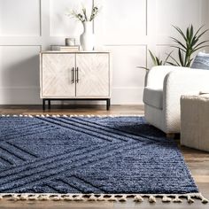 a living room with a blue rug on the floor