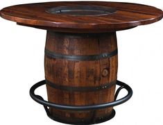 a wooden barrel table sitting on top of a metal base