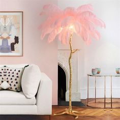 a living room with a white couch and a pink feather lamp in the middle of it