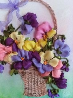 a basket filled with lots of purple and yellow flowers