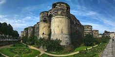 a very large castle sitting on top of a lush green field