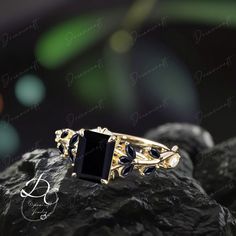 a black stone ring sitting on top of a rock