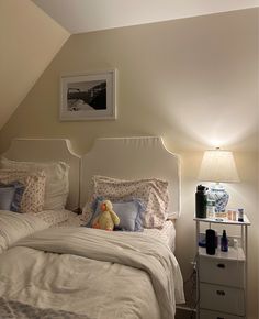 a bedroom with two twin beds and a night stand