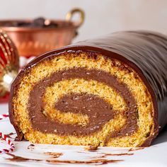 a chocolate roll is cut in half and sitting on a table with candy canes